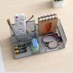 a desk organizer with a watch and other items