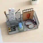 a desk organizer with a watch and other items