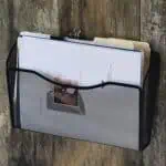 a black wire file holder with papers inside