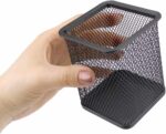 a hand holding a black mesh container