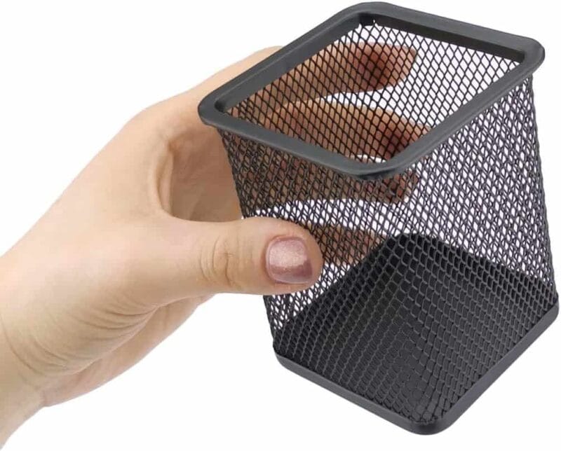 A hand holding a black mesh container