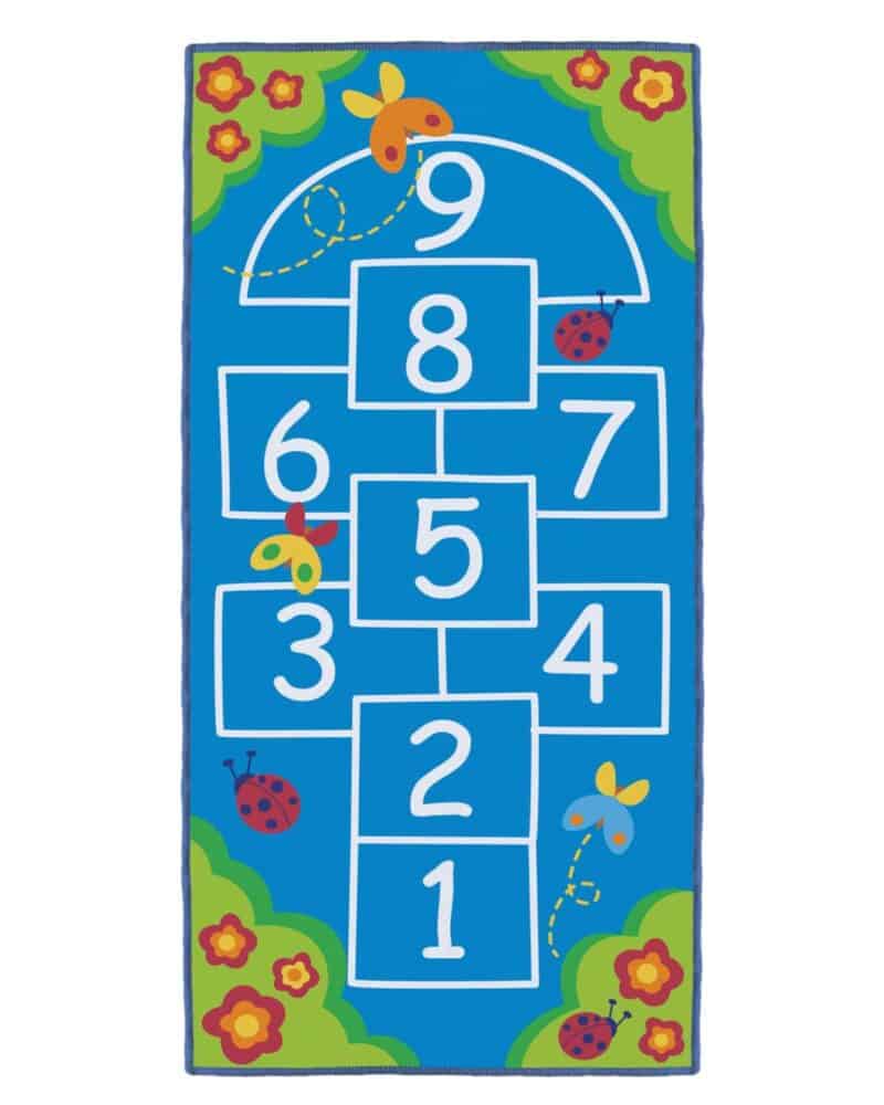 A blue rug with white numbers and butterflies