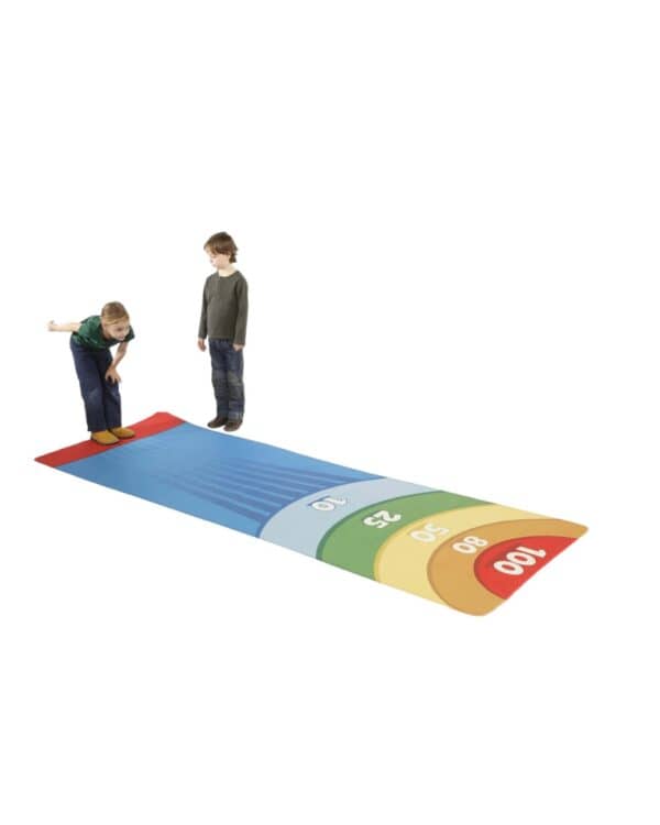 a boy standing on a colorful mat