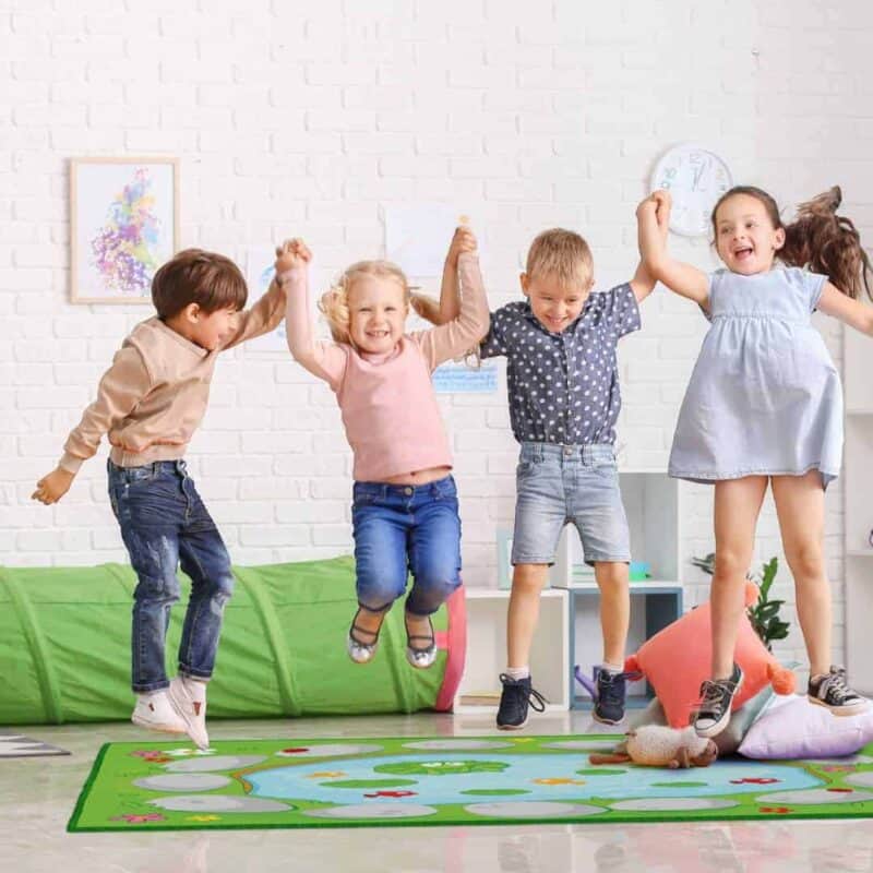 A group of kids jumping in a room