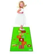 a girl standing on a hopscotch mat