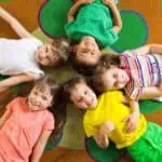 a group of children lying on a rug