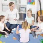 a woman and children sitting on the floor