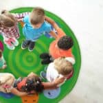 a group of children standing in a circle