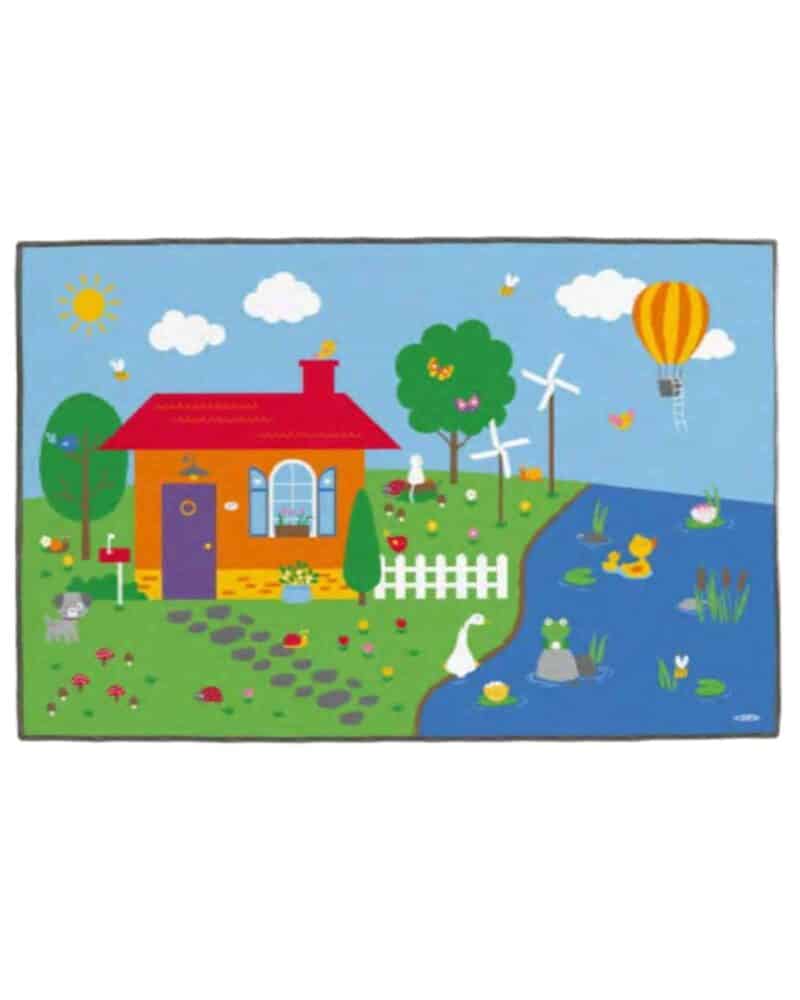 A rug with a house and a pond