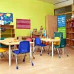 a classroom with tables and chairs