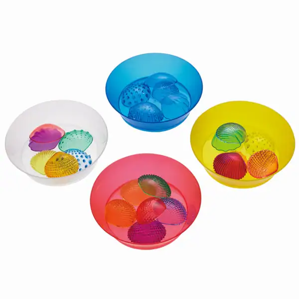 Brightly colored glass bowls containing textured glass balls in blue, yellow, pink, and white.