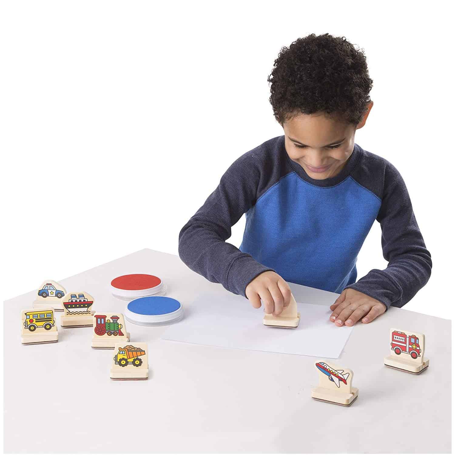 Child playing with wooden toy stamps.