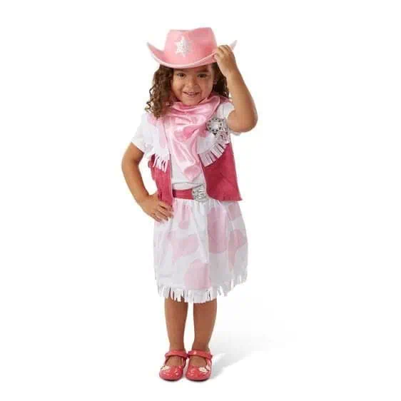 Cute girl in pink cowboy costume with hat, boots, and vest, smiling and posing confidently.