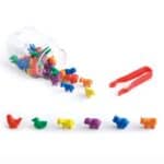 a jar with plastic animals and tweezers