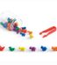 A jar with plastic animals and tweezers