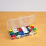 a plastic container with different colored dice