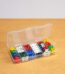 A plastic container with different colored dice