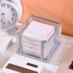 a stack of notes in a wire basket