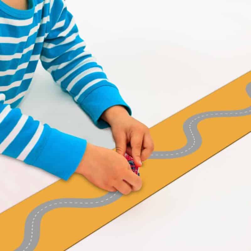 A child playing with a toy car