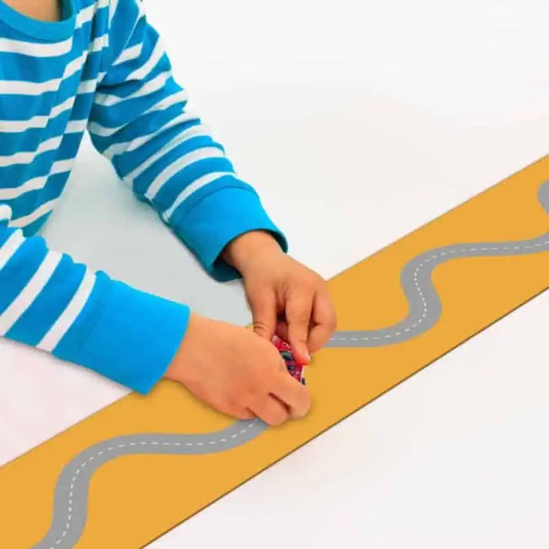 A child playing with a toy car