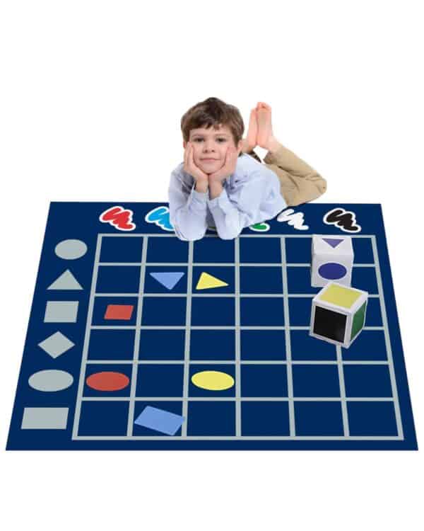 a boy lying on a blue rug with a blue mat with colorful objects on it
