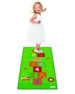 a girl standing on a hopscotch mat