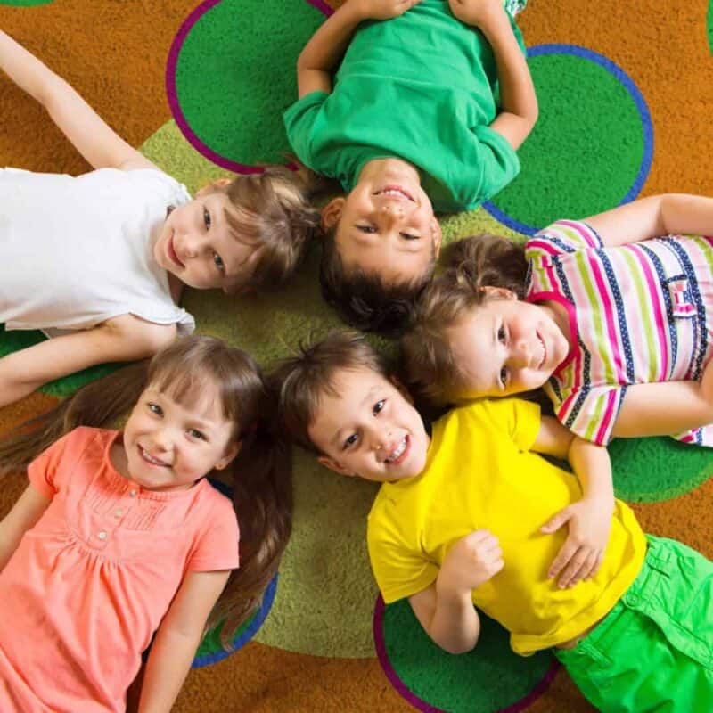 A group of children lying on a rug