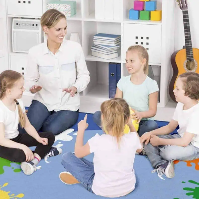 A woman and children sitting on the floor